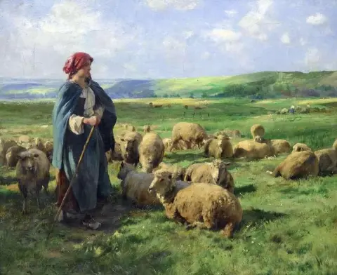 En ung herdinna som vakar över sin flock