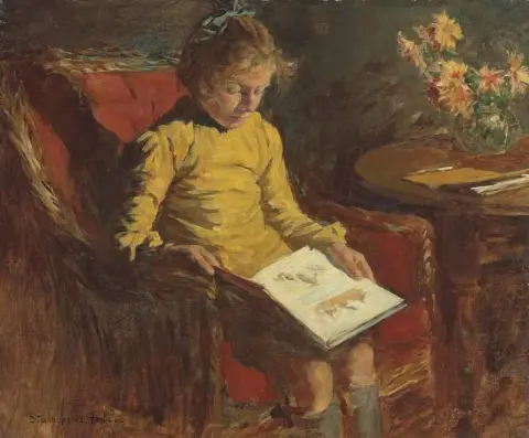 En flicka i en korgstol ca 1920
