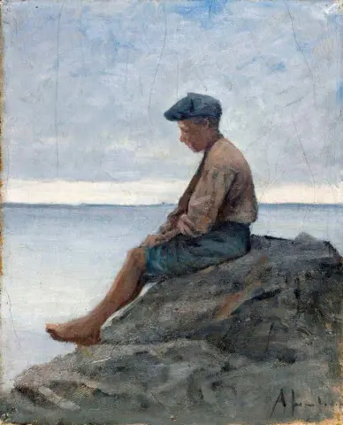 Poika istuu rannalla